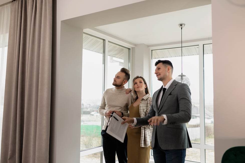 Couple Standing beside Windows